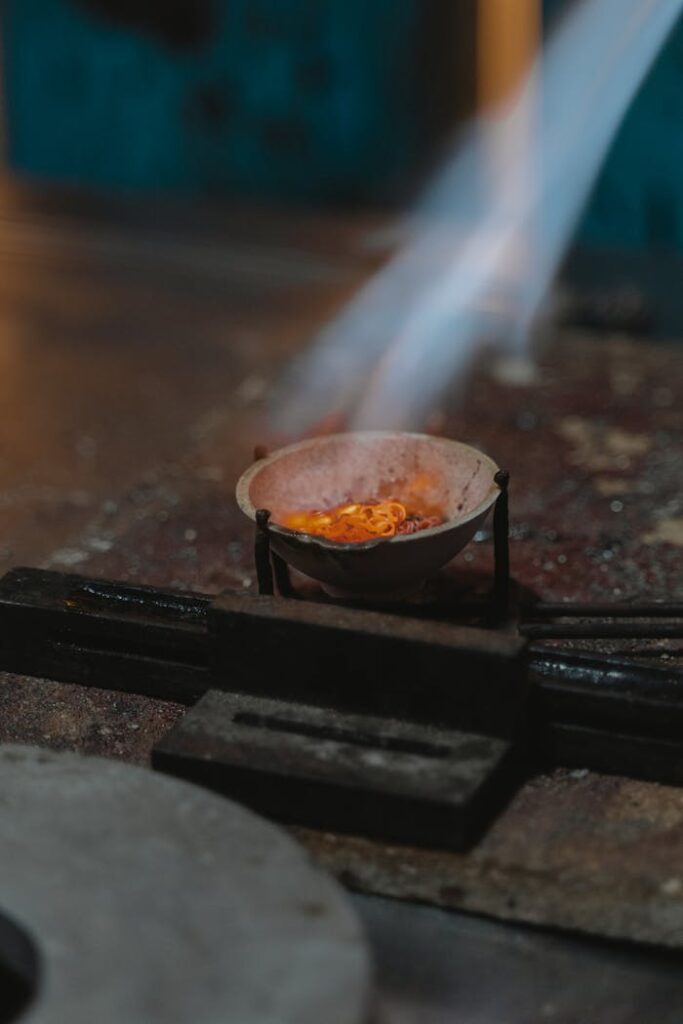 A jeweler working with molten metal to craft unique jewelry pieces.